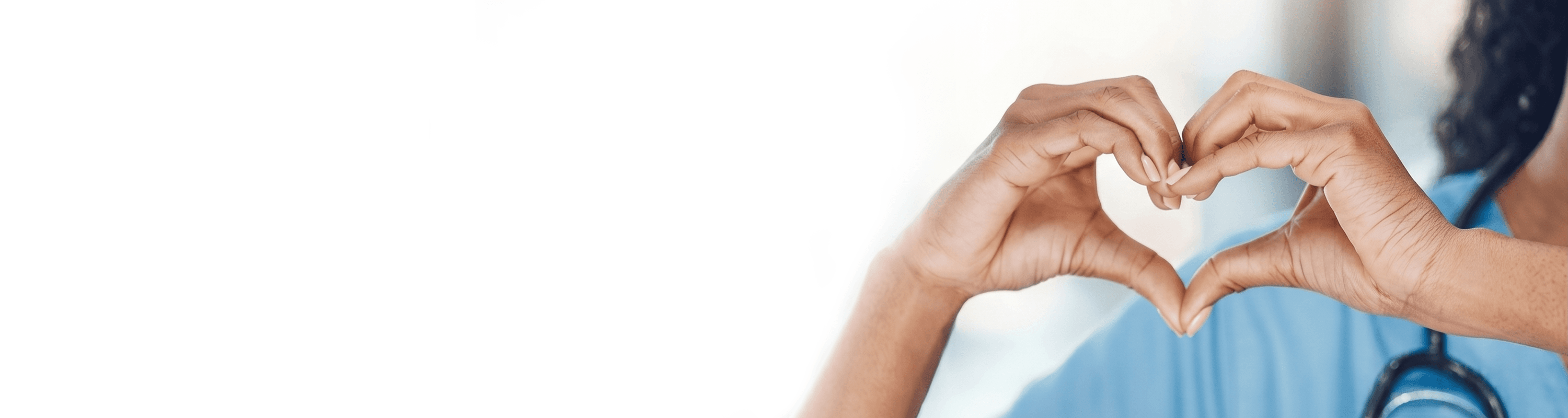 Healthcare worker forming a heart shape with their hands